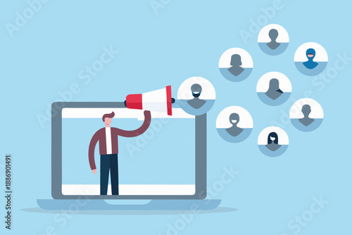 A person speaking into a megaphone from a laptop towards a group of people