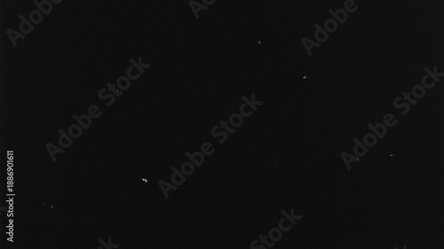 film grain texture overlay on a pure black background in 4K resolution. Subtle cinematic noise effect suitable for video editing, film look, motion graphics, transitions, and visual effects.