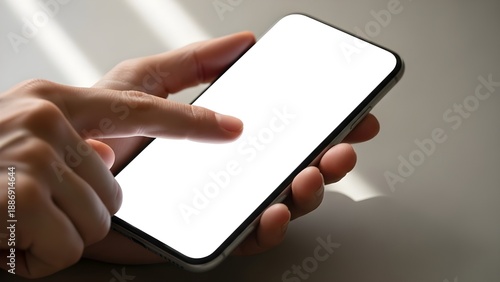 Wallpaper Mural Close-up of a hand holding a smartphone with a blank white screen, ready for user interaction or content display Torontodigital.ca