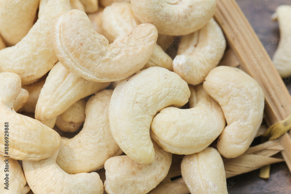 Fototapeta premium Ripe Cashew Nuts on Wooden Board - Fresh Delicious Snack