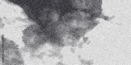 Abstract grayscale textured background with a grainy effect and soft cloud-like formations creating a moody and atmospheric visual, perfect for digital art and design projects