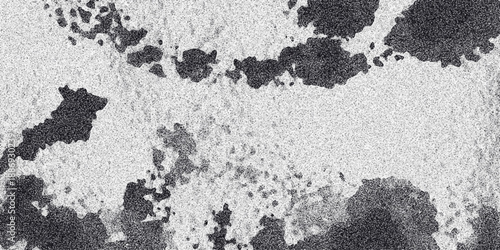 Abstract monochrome texture with dark irregular shapes and fine granular pattern creating a textured background for design projects and artistic concepts