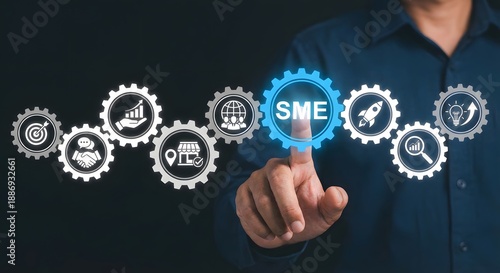 Wallpaper Mural Person's finger touching a glowing 'sme' gear icon surrounded by other business growth and strategy symbols. Torontodigital.ca