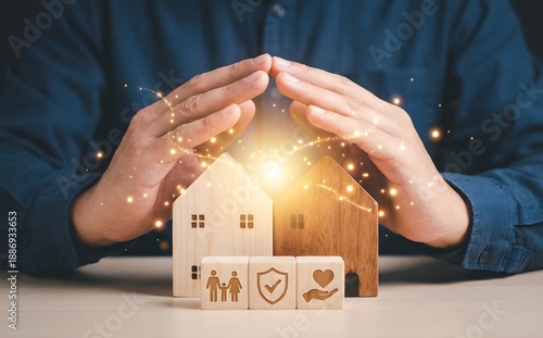 Wallpaper Mural Hands protect miniature wooden houses and symbolic blocks representing family, security, and love, illustrating care and insurance. Torontodigital.ca