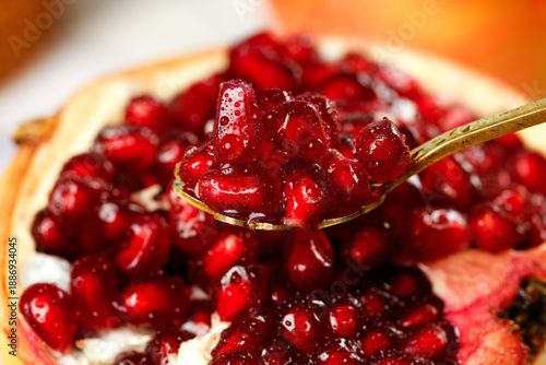 Fotografija Fresh Pomegranate Seeds on Spoon - Healthy Red Fruit