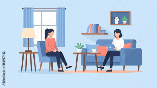 Two women in a living room, one on a couch with a laptop, the other in a chair