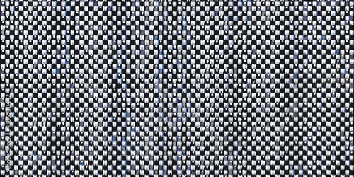 Close up of a woven fabric displaying a checkered pattern with dark and light tones