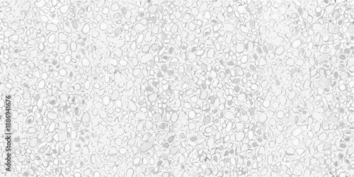 Close up view of a textured white surface with scattered grey details