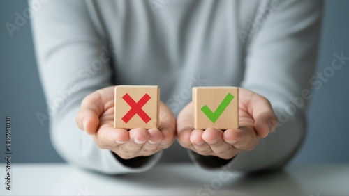 Person holding wooden blocks with a red cross and green checkmark representing decision making and acceptance or denial