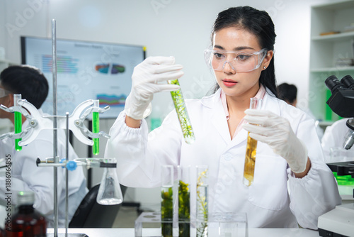 Scientist examining plant-based samples in a modern laboratory, representing sustainability, biotechnology, clean energy, and climate action concepts for ESG, green innovation, corporate communication