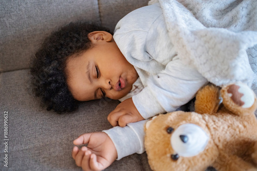Wallpaper Mural Baby sleeping peacefully with teddy bear on couch Torontodigital.ca