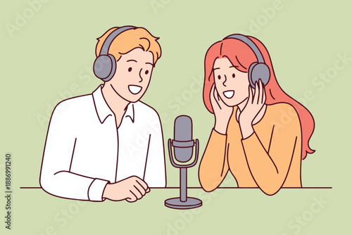 Guy and girl sitting in front of microphones recording professional news podcast