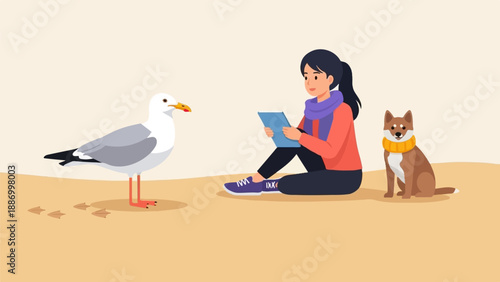 Woman with dog and seagull sitting on sand, reading on tablet