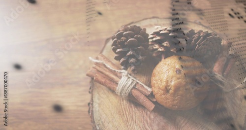 Showing arrangement on wooden table with slice, three cones, tied cinnamon, muffin, printed overlay