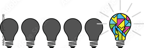 A single bright colorful lightbulb shines as a unique idea among several dark bulbs