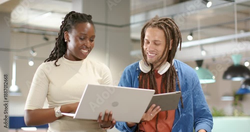 Wallpaper Mural African American coworkers at office woman presenting laptop, man pointing tablet, checking data Torontodigital.ca