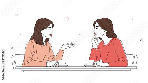 Two young women wearing peach and red sweaters sitting at a table and having a pleasant conversation over cups of coffee.