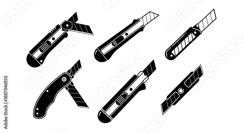 Collection of utility knives and blades arranged on a white surface, showcasing various designs and mechanisms