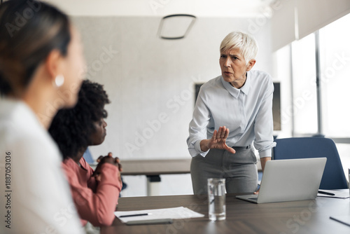 Photos Female manager having intense conversation with employees during meeting