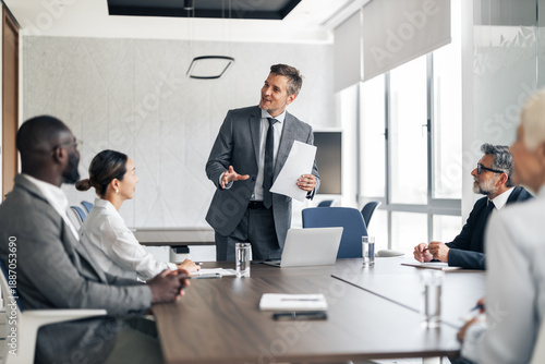Photos Businessman presenting information during corporate business meeting