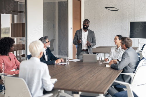 Photos Diverse business professionals having corporate meeting in boardroom