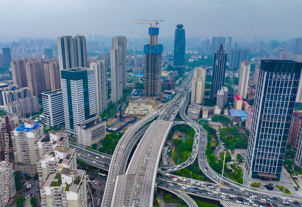Obraz premium Aerial View of Wuhan City with Elevated Highway Interchange and Modern Skyline