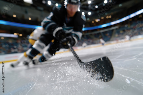 A dynamic moment captured as a hockey player skillfully maneuvers on the ice, showcasing the excitement and speed of the game in an arena setting.