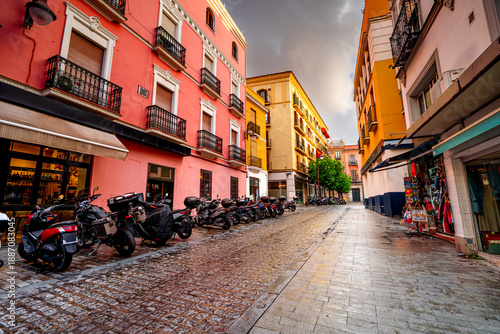 Colorful narrow streets in Seville, Andalusia. Classic view of a Spanish city.