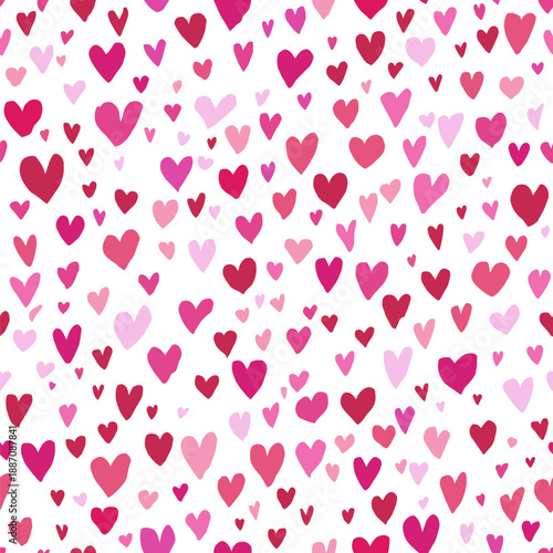 Pink hand-drawn hearts forming a seamless pattern on a white background. Pink heart pattern creating simple love background
