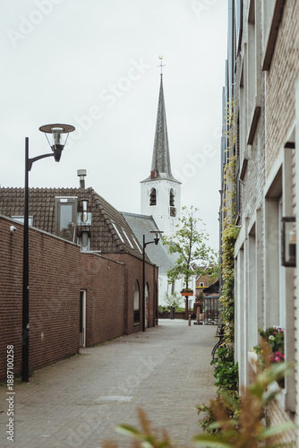 White church, vertical image of the building exterior of the Witte Kerk in the centre of a Dutch village Noordwijkerhout outdoor at daytime during springtime season in The Netherlands.