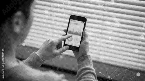 A person holding a smartphone in their hand with a screen showing an app or interface in a modern technology concept