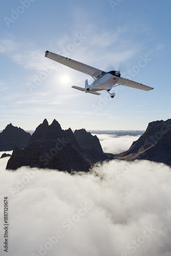 Wallpaper Mural Small Plane Flies Over Jagged Mountain Range Above Clouds At Sunrise Torontodigital.ca