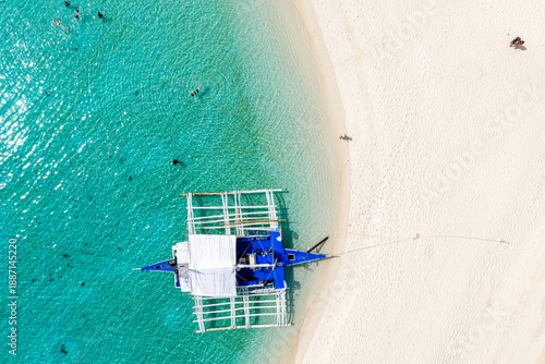 High Angle Drone Shot of Malapascua Island Surrounded by Vibrant Coral Reefs and Deep Blue Sea.