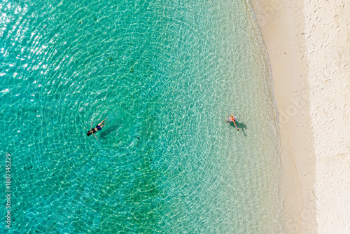 Top-down Aerial View of Tourists Swimming and Floating in Crystal Clear Turquoise Tropical Water.