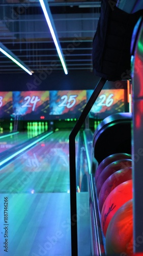 Modern bowling alley interior with neon lights and vibrant graffiti numbers.