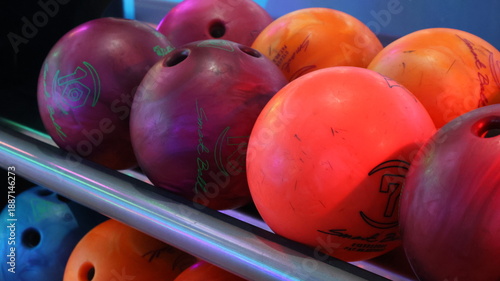 Modern bowling alley interior with neon lights and vibrant graffiti numbers.