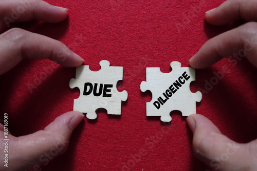 Hands connecting puzzle pieces labeled due and diligence