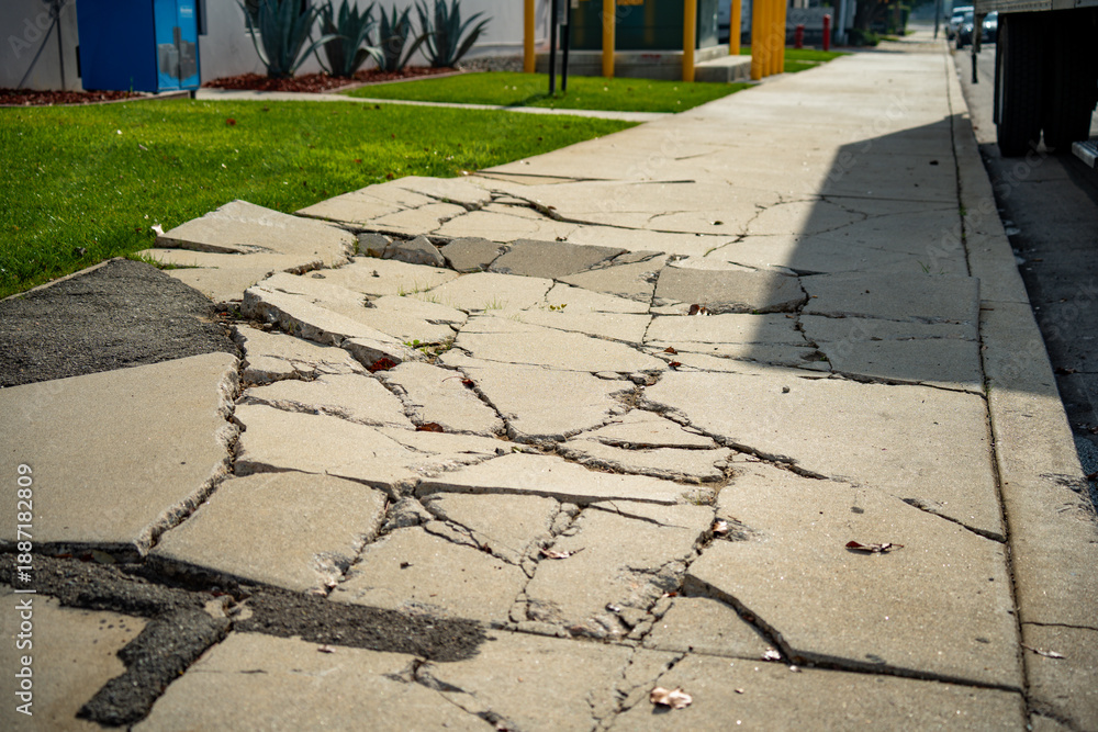 Ταπετσαρία Damaged concrete sidewalk with large cracks and uneven slabs on a sunny day
