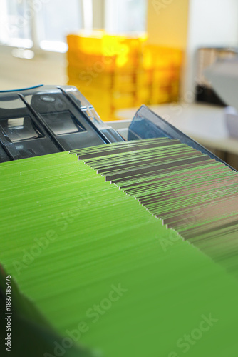 An enveloping machine at the lettershop prepares and processes letters and mailings for the post office or print shop. Print sorted with spine. Lettershop or bookbinder manufacture.