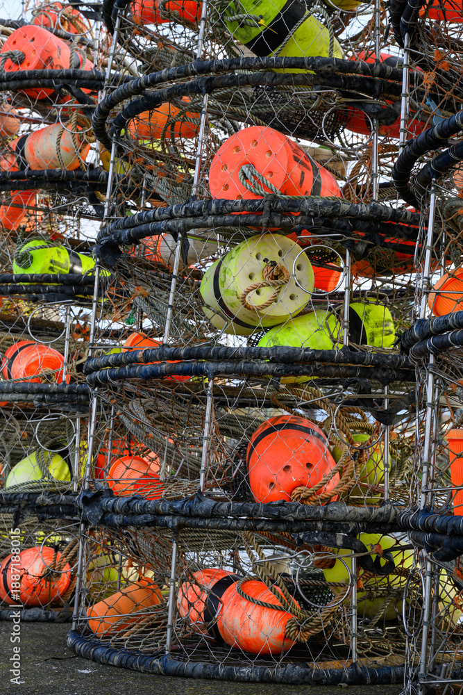 Fototapeta premium Closeup of pile of fishing crab pots with colored floats on pier