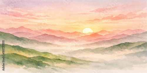 A beautiful orange light illuminates the horizon as the sun sets over a natural mountain landscape with soft clouds and blue fog during a summer evening view