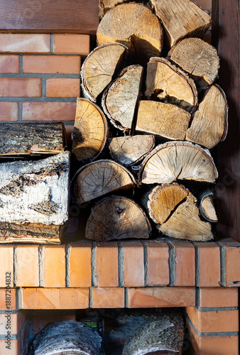 Wallpaper Mural Firewood against the brick wall of a fireplace in a country house. The problem of heating homes in a frosty winter. Torontodigital.ca