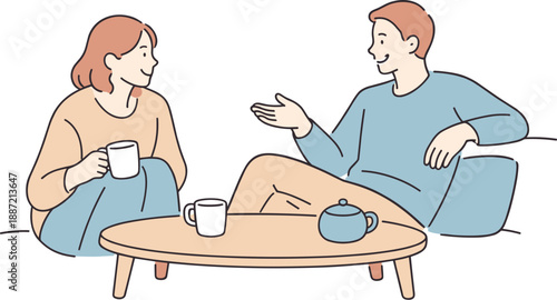 Friends chatting around a coffee table together, two people sitting comfortably with cups nearby and relaxed smiles sharing an