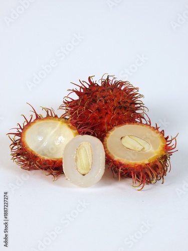 Fresh rambutan fruits whole and sliced on white background
