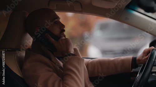 Man in Car Answers Phone Call, Engaged in Modern Communication