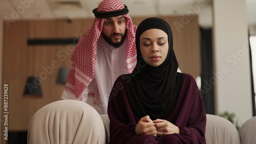 Angry Arab man yelling at unhappy wife, marriage crisis and family conflict