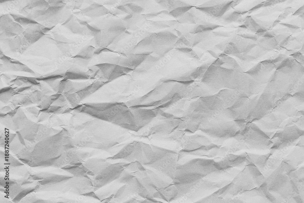 Obraz premium Crumpled white paper texture background,A high-resolution top view of a wrinkled and crumpled piece of white paper, showing detailed creases, shadows, and textures, ideal for background or overlay.