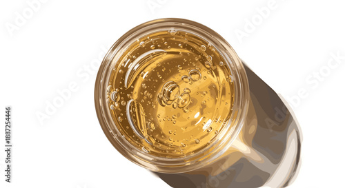 Aerial view of a glass filled with a refreshing golden drink, showcasing its clarity and freshness in a transparent container