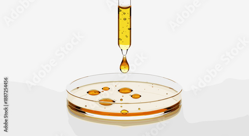 A pipette drips yellow liquid into a petri dish containing a brown substance, viewed from directly above in a laboratory setting.