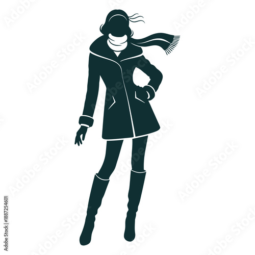 Fashionable woman in coat and boots standing confidently